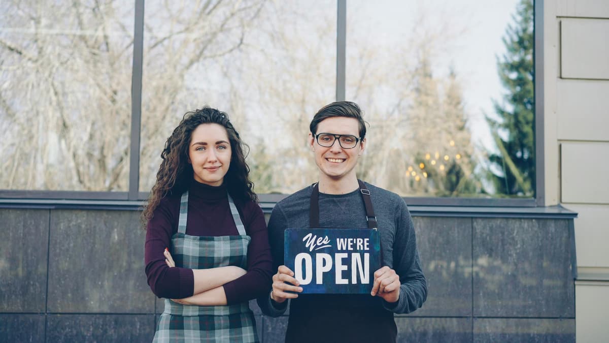 Proud small business owners outside their shop